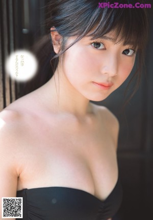 A woman in a school uniform is posing for a magazine cover.