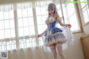 a woman in a blue and white dress posing for a picture