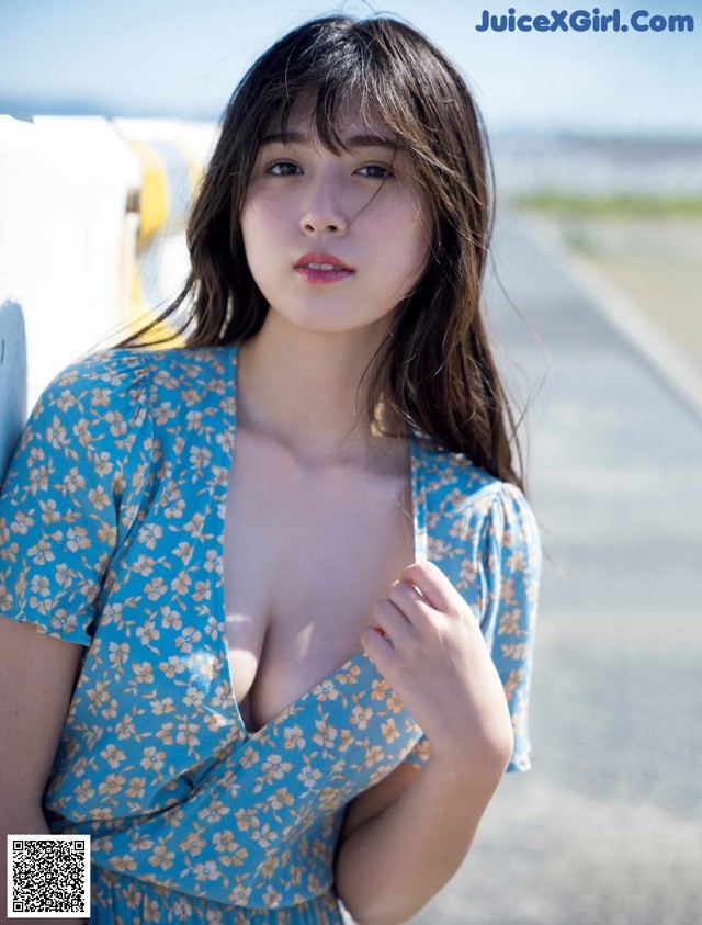 A woman in a blue dress posing for a picture.
