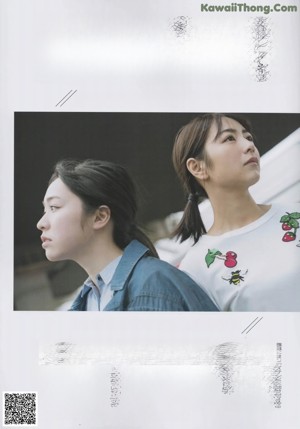 A woman in a white shirt is posing for a magazine.