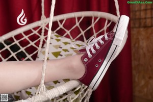 a close up of a person's foot on a tiled floor
