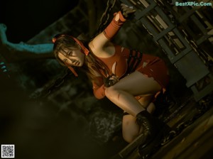 A woman in a red dress sitting on the ground.