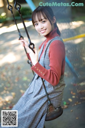 A young woman in a blue shirt posing for a picture.
