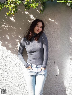 A woman in a white lingerie posing for the camera.