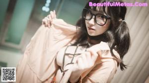 A woman wearing glasses and stockings sitting on a bench.